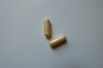 Naklejka premium 2 beige capsules of milk thistle extract from above