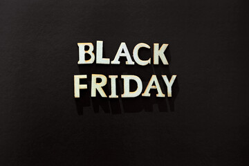 Words black friday. Wooden letters with lettering on top of black background