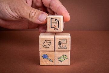 Education, Skills and Learning concept. Wooden blocks with icons on a brown background