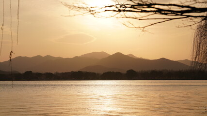 The beautiful sunset view with the lake and mountains as background in winter