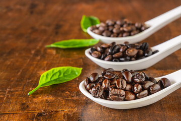 A collage of coffee beans in spoon showing various stages  through to roast