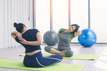 Fototapeta na wymiar middle-aged woman practicing yoga in sports club