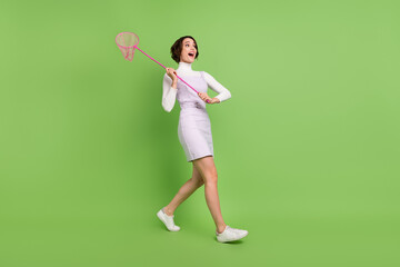Full length body size photo girl catching insects with net isolated pastel green color background - obrazy, fototapety, plakaty