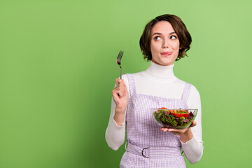 Photo portrait woman keeping salad hungry looking copyspace isolated pastel green color background