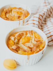 Homemade apricot clafoutis, traditional summer French sweet fruit pie.