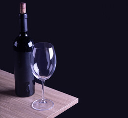 wine glass with bottle and black background