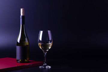 wine glass with bottle and black background