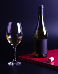 wine glass with bottle and black background