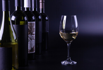 wine glass with bottle and black background