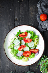 fresh salad organic vegetables tomato, cucumber, pepper, onion, lettuce meal snack copy space food background rustic. top view keto or paleo diet veggie vegan or vegetarian food
