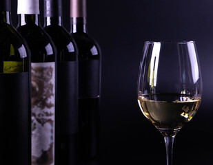 wine glass with bottle and black background