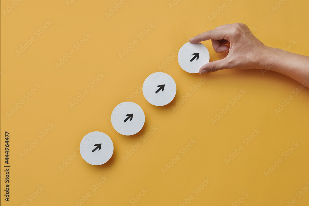 Poster paper mugs with drawings of up arrows on them. a symbol of development and moving forward in life