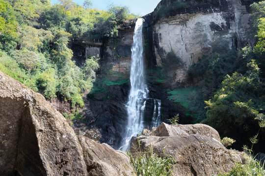 Beautiful Ramboda Falls landscape photograph. It's also going by the name of Puna Ella. A powerful stream of water falling down through the high rocky mountain,