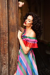 Fototapeta premium Woman wearing flowers dress in hot summer city