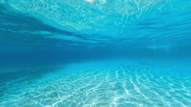 Underwater video, stunning view of a tourist swimming on a beautiful and turquoise water. Caprera, La Maddalena Archipelago, Sardinia, Italy.