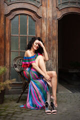 Beautiful woman in the flowers dress in summer city
