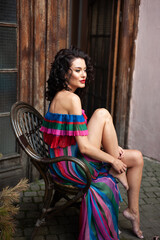 Beautiful woman in the flowers dress in summer city