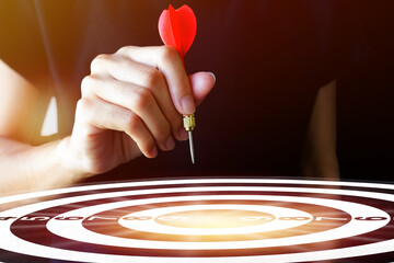 Success goals Targeting the business concept. Businessman throwing red arrow dart to virtual target...