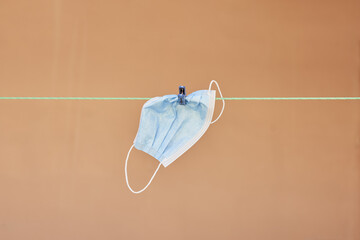 Medical disposable face mask hanging on the rope