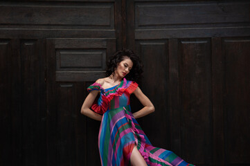 Beautiful woman in the flowers dress in summer city