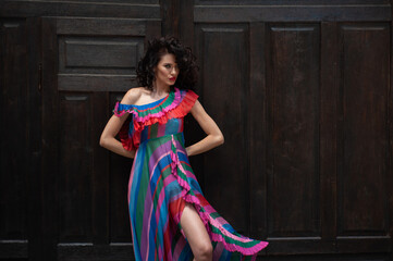 Beautiful woman in the flowers dress in summer city