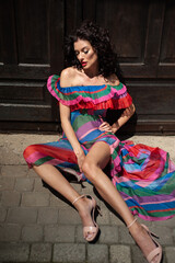 Fototapeta premium Beautiful woman in the flowers dress in summer city