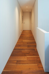 White hallway with spotlights in a stylish modern home. White walls, perfect for your text