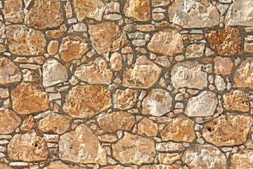 Rocky texture. Sandstone wall in medieval cathedral style. Chaotic masonry structure.