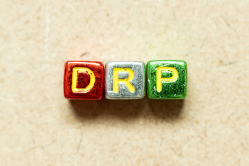 Metallic color alphabet letter block in word DRP on wood background