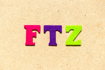 Color cloth alphabet letter in word FTZ (Abbreviation of Free trade zone) on wood background