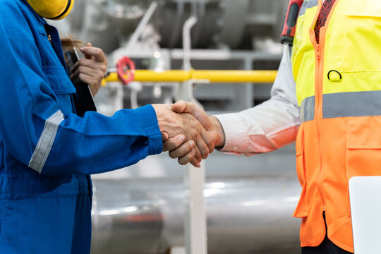 Engineer handshake for teamwork of business merger and acquisition,successful negotiate,hand shake,two Engineer shake hand with partner to celebration partnership and business deal concept
