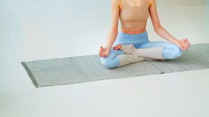 Young woman meditating in lotus position