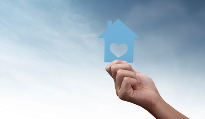 Naklejka premium Hands holding paper house, family home protecting insurance concept