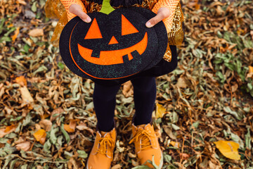 Pumpkin lantern in the hands of a child for Halloween.