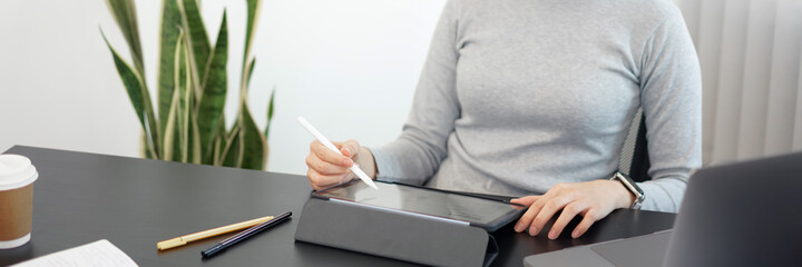 Office work concept a female officer using her tablet to work on a document job in the office
