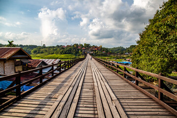 Fototapeta premium Mon Bridge, old wooden bridge at sunset in Sangkhlaburi, Kanchanaburi, Thailand
