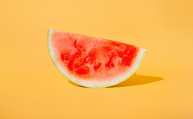 a slice of juicy appetizing red watermelon on an isolated yellow background. the concept of summer