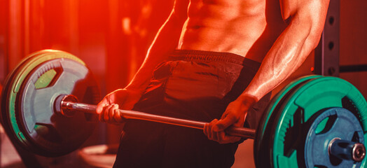 Closeup deadlift barbells workout. Workout the gym. Athletic man with six pack, perfect abs