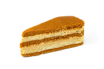 Slice of honey cake isolated on white background.