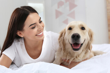 Happy woman with her cute pet dog at home