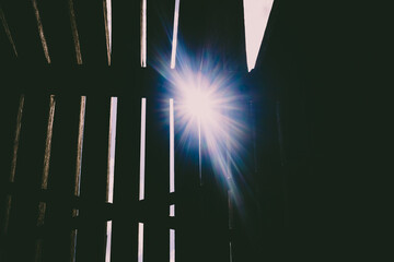 The light shines through the old wooden planks, a background to design with retro and vintage style.