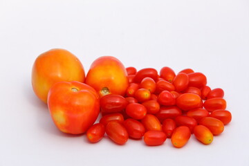 Group of fresh red tomatoes isolated on white background