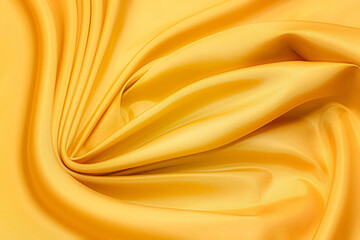 Silk fabric taffeta ocher in artistic layout. Texture, background, pattern.