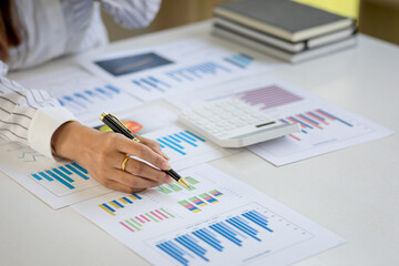 Businesswoman hands hold documents with financial statistic stock photo,discussion and analysis data the charts and graphs. Finance concept