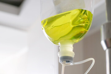 Close-up of a rehydration bottle hanging on a stand for use with a patient.