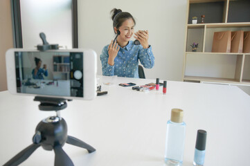 Professional Woman blogger vlogger is showing cosmetics products with recording video  makeup...
