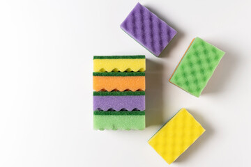 Fototapeta na wymiar colored washcloths for washing dishes on a white background, top view
