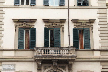 Fototapeta na wymiar Rome White Building Facade Detail with Balcony and Green Shutters, Prati District
