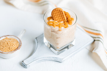 Caramel cheesecake in glass with biscuit 