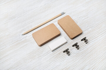 Branding mock up. Photo of blank corporate identity. Kraft business cards, pencil and eraser. Stationery set on light wooden background.